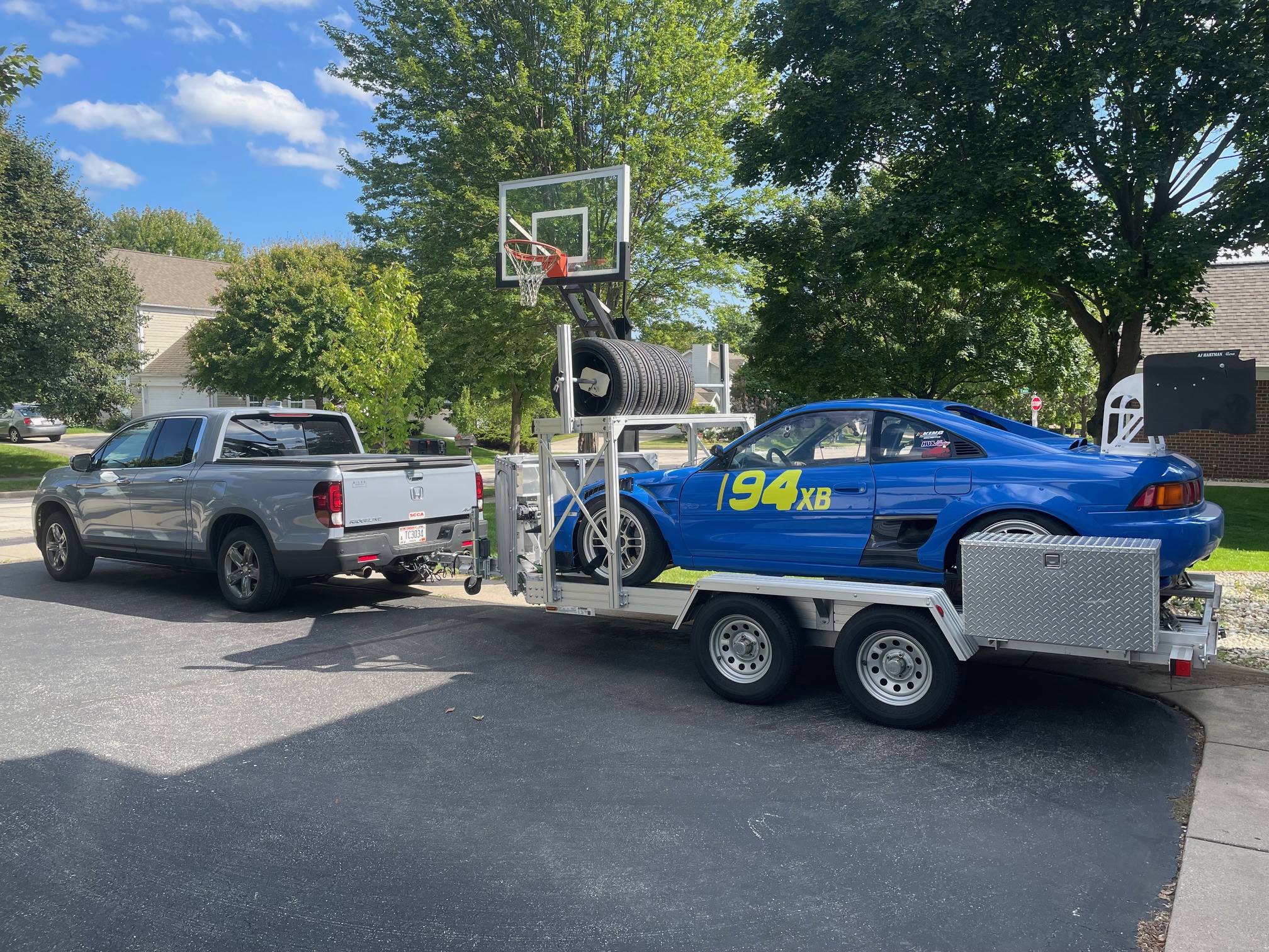 Honda Ridgeline towing an open car trailer